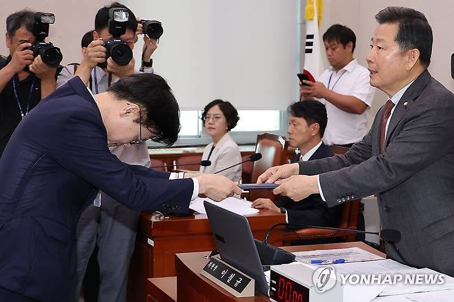 선서문 전달하는 김정관 산업통상자원부 장관 후보자 (서울=연합뉴스) 김주성 기자 = 김정관 산업통상자원부 장관 후보자가 17일 국회 산업통상자원중소벤처기업위원회에서 열린 인사청문회에서 선서 후 이철규 위원장에게 선서문을 전달하고 있다. 2025.7.17 utzza@yna.co.kr