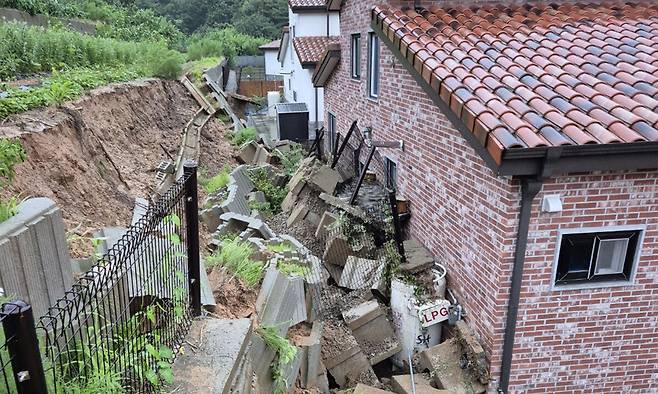 17일 충북 음성군 한 주택 뒤 옹벽이 무너져 액화석유가스 가스통이 파손됐다. 충북소방본부 제공