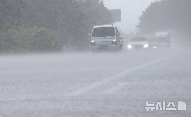 [제주=뉴시스] 우장호 기자 = 비구름대가 활성화한 18일 오후 제주시 용강동 제주마 방목지 인근 도로에 강한 빗줄기가 쏟아지고 있다. 2025.07.18. woo1223@newsis.com
