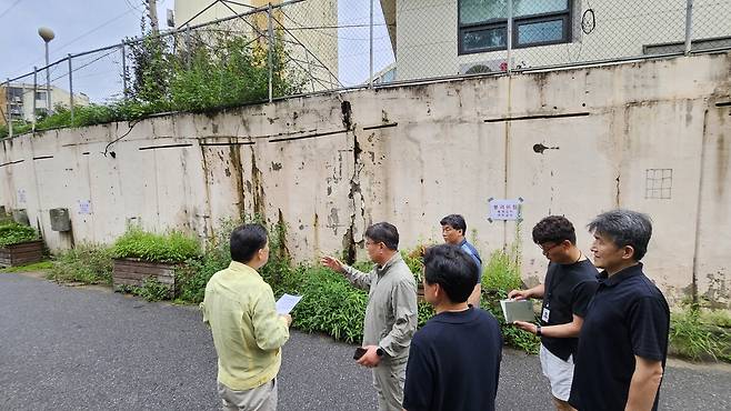 이재준 수원시장(사진 왼쪽 첫번째)와 김태관 도시개발국장(두번째) 등 관계자들이 권선구 서둔동의 한 아파트 옹벽 갈라짐 현장을 점검하고 있다.<수원시 제공>