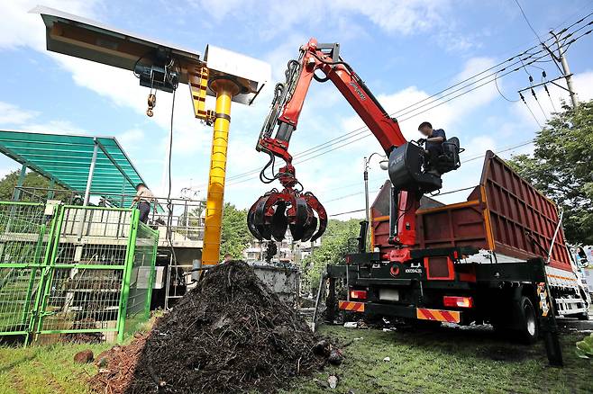 18일 오전 대구 북구 노곡동 빗물펌프장에서 시설 관계자들이 집게크레인을 동원해 전날 집중호우 때 쌓인 쓰레기와 나뭇가지 등 찌꺼기를 제거하고 있다./뉴스1