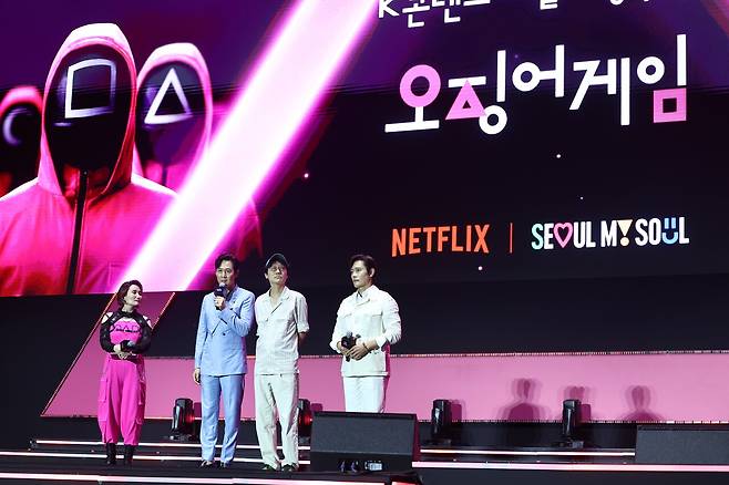 6월28일 서울광장에서 열린 <오징어 게임> 시즌 3 팬 이벤트 무대에 오른 배우 이정재와 황동혁 감독, 배우 이병헌(왼쪽 두 번째부터). ⓒ연합뉴스