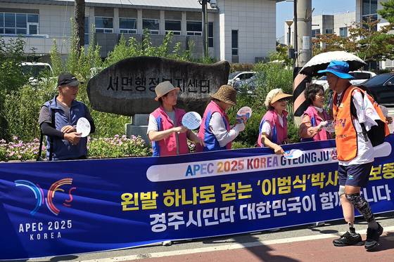 아시아태평양경제협력체(APEC) 정상회의 성공개최를 기원하며 국토 걷기에 나선 '왼발박사' 이범식씨가 24일 APEC 개최도시인 경북 경주에 도착해 시민 환영을 받으며 걷고 있다. 사진 경주시