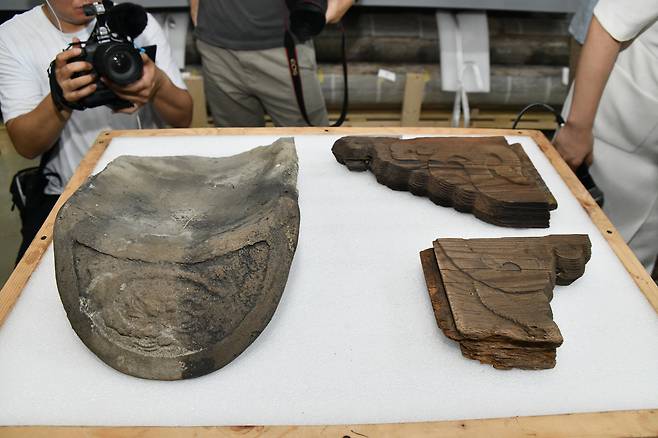 Major fragments from the repatriated Gwanwoldang are revealed to press during a press conference at the Traditional Architecture Elements Conservation Center in Paju, Gyeonggi, on July 23. [KOREA HERITAGE SERVICE]