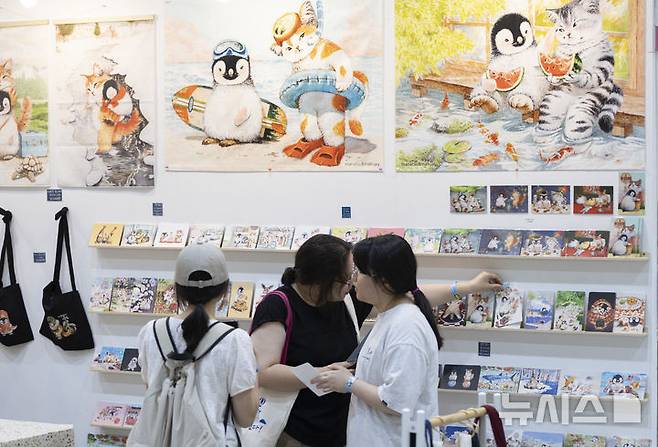 [서울=뉴시스] 김근수 기자 = 서울일러스트레이션페어V.19 2025 개막 첫 날인 24일 서울 강남구 코엑스에서 관람객들이 캐릭터 엽서를 고르고 있다. 2024.07.24. ks@newsis.com