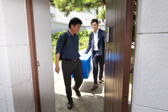 내란특검팀 관계자들이 24일 오후 서울 종로구 한덕수 전 국무총리 자택의 압수수색을 마친 뒤 압수품을 들고나오고 있다. [뉴스1]