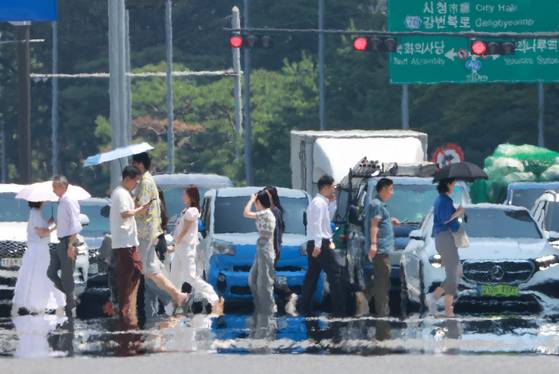 전국 대부분 지역에 폭염 특보가 발효된 25일 서울 영등포구 여의도 여의대로에 아지랑이가 피어오르고 있다. [연합뉴스]