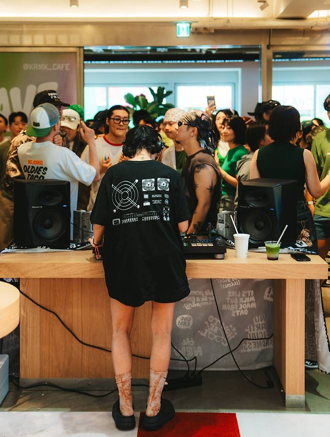 An early morning dance party at a café, with cups of coffee and matcha seen atop the DJ booth./Seoul Morning Coffee Club