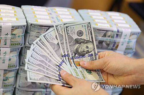 A clerk checks U.S. dollar notes at a center of Hana Bank in Seoul on Dec. 19 in 2024. [Yonhap]