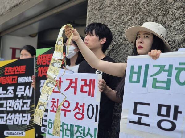 ▲허핑턴 노조 측은 테이프를 붙여 길게 이은 5만원권 지폐들을 흔들어 보이기도 했다. 이들은 “한겨레 경영진이 노동자들을 인간으로 보지 않고, 돈으로 본다는 뜻”이라고 했다. 사진=김예리 기자