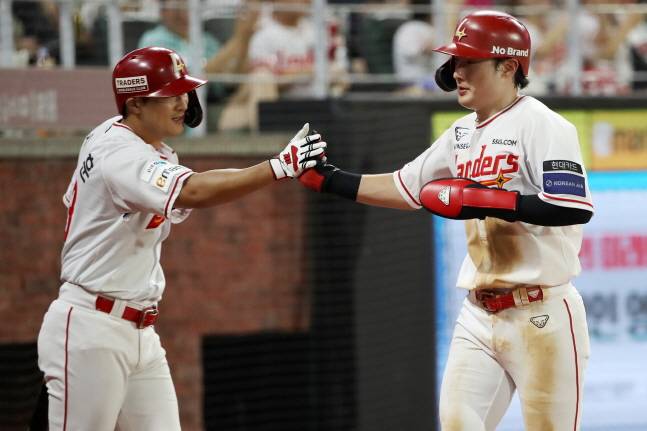 최지훈(오른쪽)이 득점 후 하재훈과 하이파이브를 하고 있다. /사진=SSG 랜더스 제공