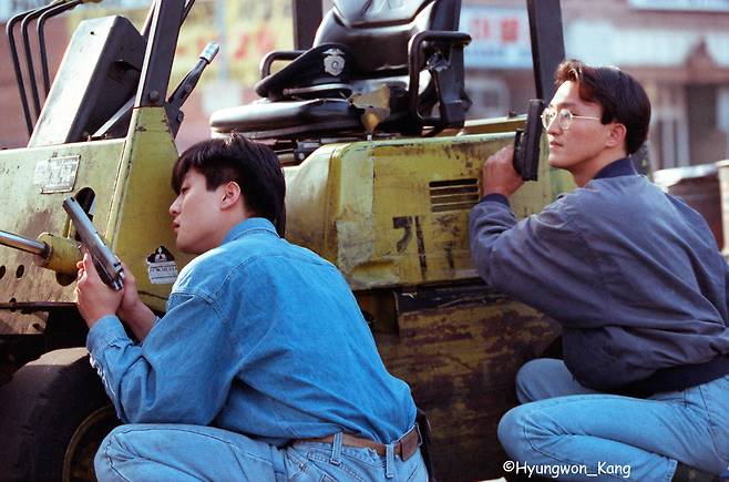 LA 폭동 둘째 날인 1992년 4월 30일, 경찰들이 한인타운에서 철수하자 총으로 무장한 뒤 폭도들과 대치하고 있는 한인 청년들. 이 사진을 포함한 일련의 LA 폭동 사진으로 1993년 한국인 최초로 퓰리처상을 수상했다. /© 강형원 LA타임스
