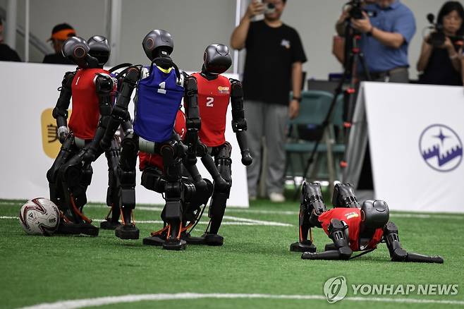 침대축구 휴머노이드 로봇 종합 운동회(14∼17일)에 앞서 4일 베이징에서 열린 휴머노이드 로봇 축구 시범경기 도중 로봇 한대가 넘어진 모습. [EPA=연합뉴스]