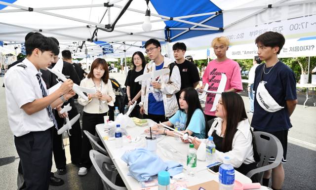 지난해 5월 경남대 개교 78주년 기념 한마대동제 페스타 위크(Festa Week)에서 관광학부 학생들이 외국유학생들에게 항공기 비행 원리를 설명하고 있다./경남신문DB/