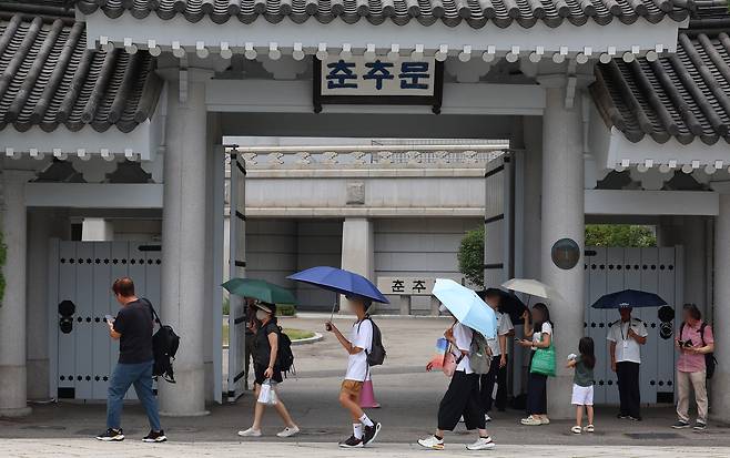 Visitors walk past a gate at the Cheong Wa Dae compound on Thursday. (Yonhap)