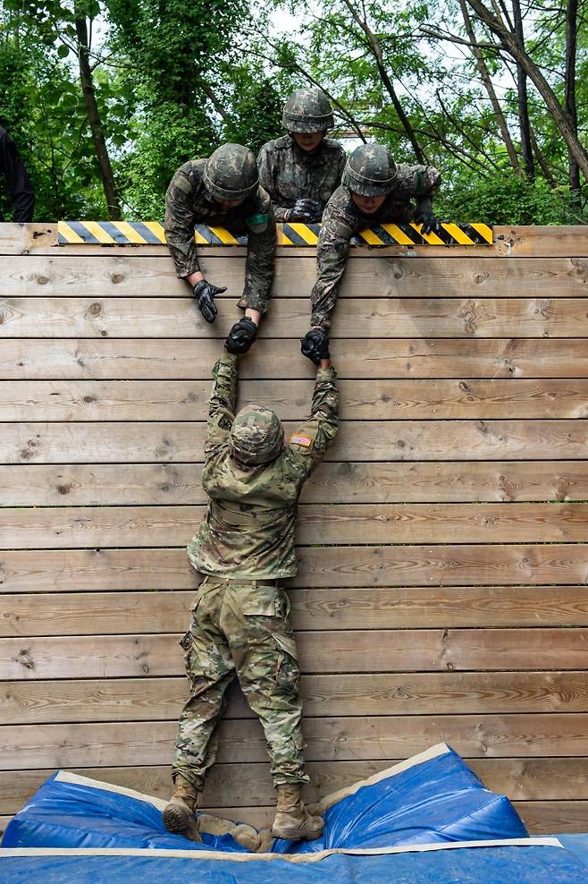 육군이 지난 7일부터 8일 충북 괴산 육군학생군사학교에서 '한미 ROTC 사관후보생 동반훈련'을 실시했다고 8일 밝혔다. 사진은 양국의 후보생들이 힘을 모아 담장을 넘어가고 있는 모습. 육군 제공