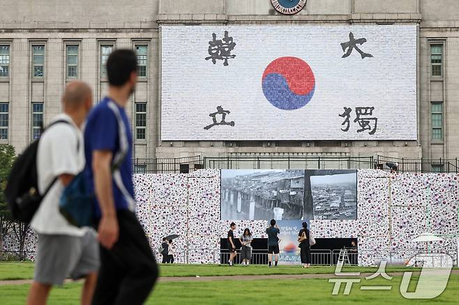 8일 오후 서울 중구 서울도서관 앞에 광복 80주년을 맞아 설치된 '태극기 언덕' 앞으로 시민들이 오가고 있다. 2025.8.8/뉴스1 ⓒ News1 민경석 기자