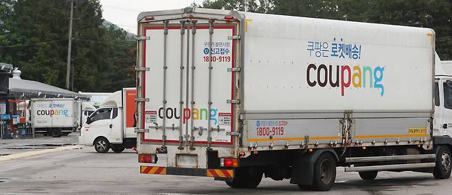 Coupang delivery trucks sit parked at a company logistics hub in Seoul on Wednesday. (Yonhap)