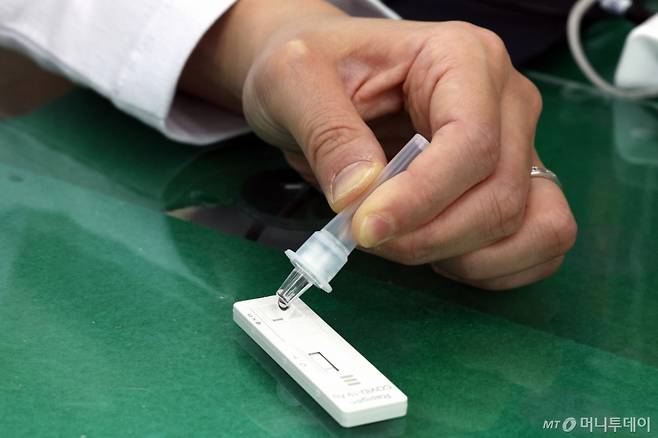 (서울=뉴스1) 신웅수 기자 = 신종 코로나바이러스 감염증(코로나19)이 재유행하고 있는 18일 서울 종로구 새종로약국에서 약사가 코로나19 자가 키트를 구매하는 고객에게 사용법을 알려주고 있다.  코로나19 환자가 6주 만에 약 22배로 폭증하면서 치료제와 진단키트 품귀 현상이 전국 곳곳에서 발생하고 있다.  생산공장에서는 재고가 바닥나 공장을 풀가동하고 있는 상황이며 진단키트 제조업체들은 이번주 공급 물량도 납품 예약이 완료될 정도로 제품 조달에 어려움을 겪고 있다. 2024.8.18/뉴스1  Copyright (C) 뉴스1. All rights reserved. 무단 전재 및 재배포,  AI학습 이용 금지. /사진=(서울=뉴스1) 신웅수 기자