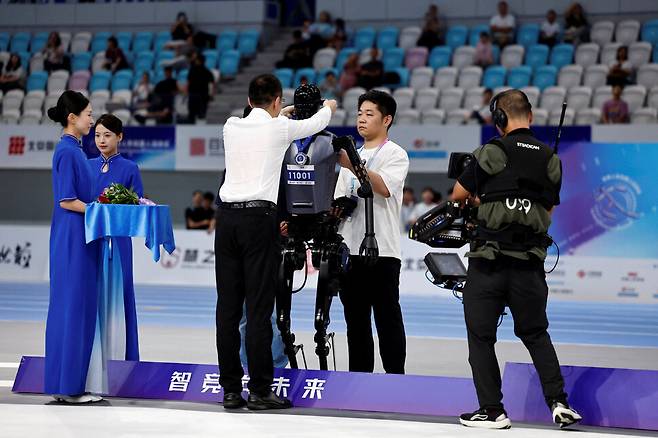 5일(현지시각) 세계 휴머노이드 로봇 게임 1500m 경기에서 톈궁 휴머노이드 로봇이 시상대에서 은메달을 목에 걸고 있다. 베이징/로이터 연합뉴스