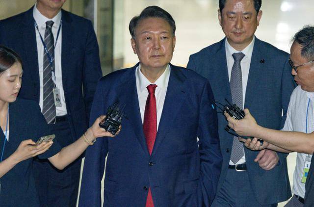 윤석열(가운데) 전 대통령이 지난달 9일 서울 서초구 서울중앙지법에서 열린 2차 구속 전 피의자 심문(영장실질심사)을 마친 뒤 구속영장 발부 여부를 기다리기 위해 서울구치소로 향하고 있다. 사진공동취재단