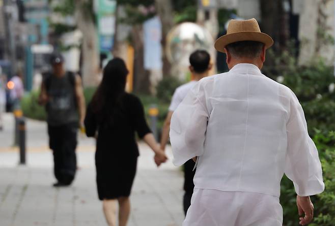 An older person walks by Nagwon Arcade in Jongno District, central Seoul, on July 29. [YONHAP]