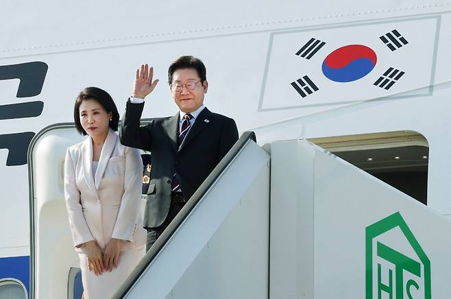일본 방문 일정을 마친 이재명 대통령과 김혜경 여사가 24일 도쿄 하네다공항에서 도널드 트럼프 미국 대통령과의 한미 정상회담을 위해 워싱턴DC로 향하며 공군1호기에 올라 인사하고 있다. 사진=뉴시스