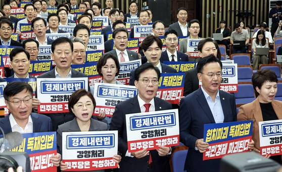 국민의힘 의원들이 25일 오전 서울 여의도 국회에서 의원총회를 열고 집중투표제 의무화 등의 내용을 담은 상법 개정안을 여당이 일방적으로 통과시킨 것을 규탄하며 구호를 외치고 있다. 김성룡 기자