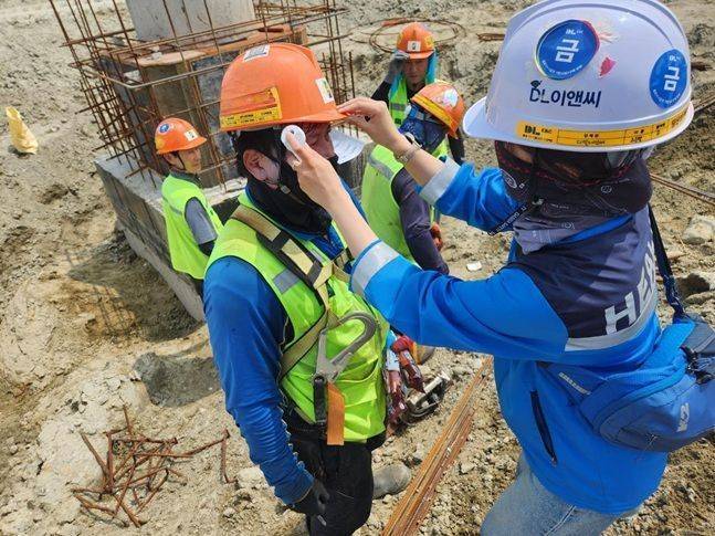 DL이앤씨 현장 안전보건관리자가 근로자의 체온을 측정하고 건강상태를 확인하고 있다. ⓒ DL이앤씨