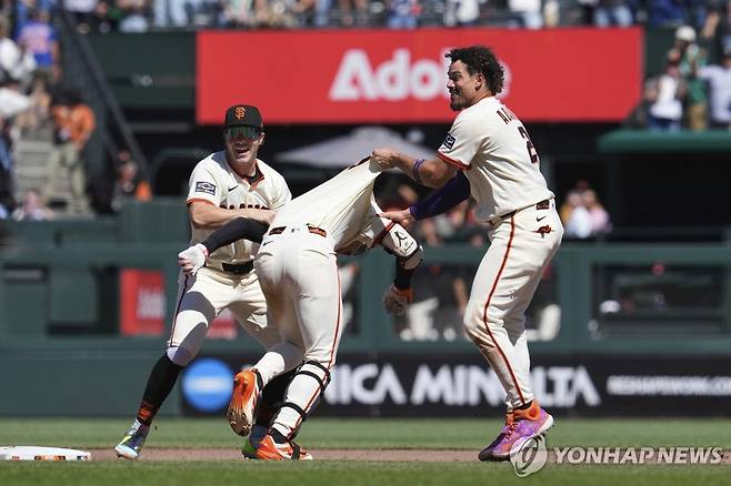 아다메스에게 잡힌 이정후 (샌프란시스코 AP=연합뉴스) 샌프란시스코 이정후(가운데)가 29일(한국시간) 미국 캘리포니아주 샌프란시스코 오라클파크에서 열린 MLB 시카고 컵스와 홈 경기에서 9회말 끝내기 안타를 친 뒤, 동료 아다메스(오른쪽)의 '격한 축하'를 받고 있다.