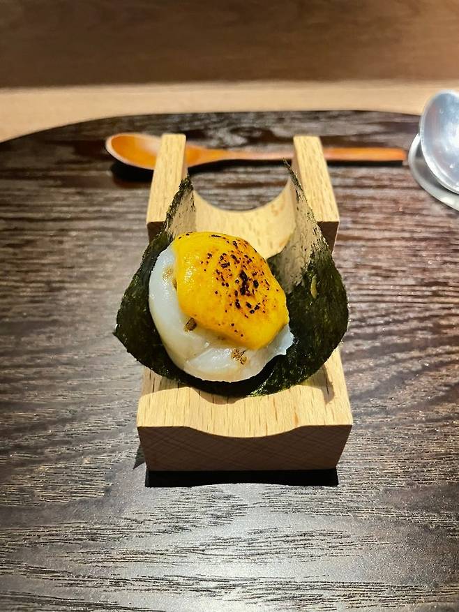 Second amuse-bouche: scallop topped with sea urchin cream, enclosed in layers of sweet, seasoned nori (Hong Yoo/ The Korea Herald)