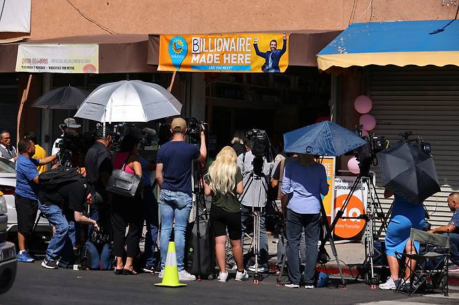 2023년 파워볼 1등이 나온 미국 캘리포니아주 로스앤젤레스 라스 팔미타스의 한 미니 마켓 앞에 언론과 사람들이 모여 있다. /연합뉴스