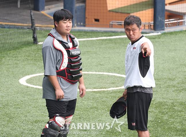 김범석(왼쪽)이 박경완 배터리 코치에게 포수 수업을 받고 있다. /사진=김진경 대기자