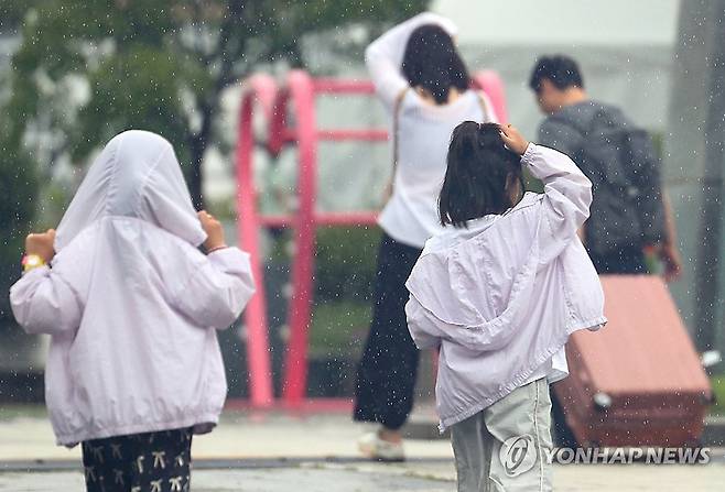 '같이 가요' (서울=연합뉴스) 김성민 기자 = 소나기가 내린 25일 오전 서울 종로구 광화문광장에서 아이들이 비를 피하기 위해 뛰고 있다. 2025.8.25 ksm7976@yna.co.kr