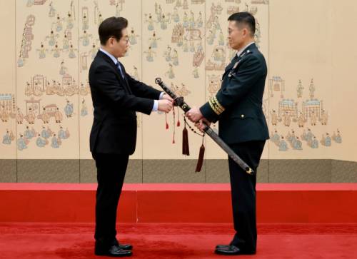 이재명 대통령이 2일 서울 용산 대통령실 청사에서 열린 대장 진급·보직 신고 및 삼정검 수치 수여식에서 김규하 육군참모총장의 삼정검에 수치를 달아주고 있다. 연합뉴스