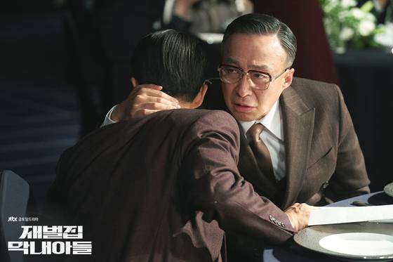 A scene from the drama series ″Reborn Rich,″ starring actors Song Joong-ki and Lee Sang-min, the latter of whom plays the head of a conglomerate. Lee's character oversees the businesses of his family-owned conglomerate, which spans dozens of different industries [SLL]