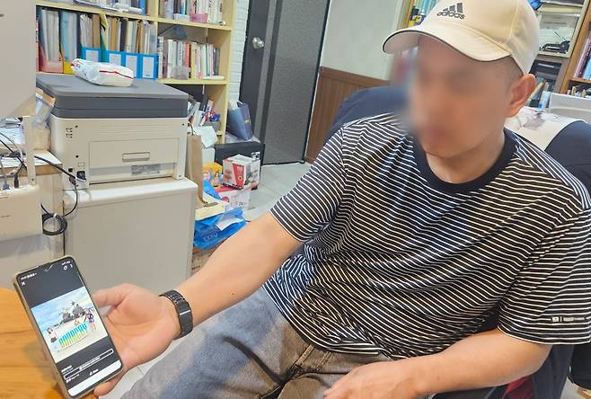 조선비즈와 만난 솔로몬씨가 필리핀 고향에 있는 가족 사진을 보여주고 있다./박성우 기자