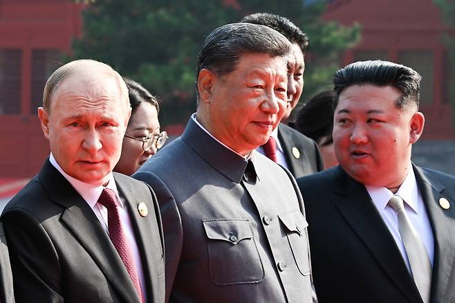 From left: Russian President Vladimir Putin, Chinese President Xi Jinping and North Korean leader Kim Jong-un are seen ahead of a military parade in Beijing on Sept. 3 to mark the 80th anniversary of Japan's defeat in World War II. [JOINT PRESS CORPS]