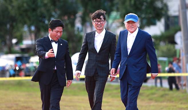 김창규 충북 제천시장(왼쪽)이 4일 오후 충북 제천비행장에서 열린 21회 제천국제음악영화제(JIMFF)에서 한국영화의 산 증인 장항준(중앙)·이장호(오른쪽) 감독을 레드카펫으로 안내하고 있다. /뉴스1