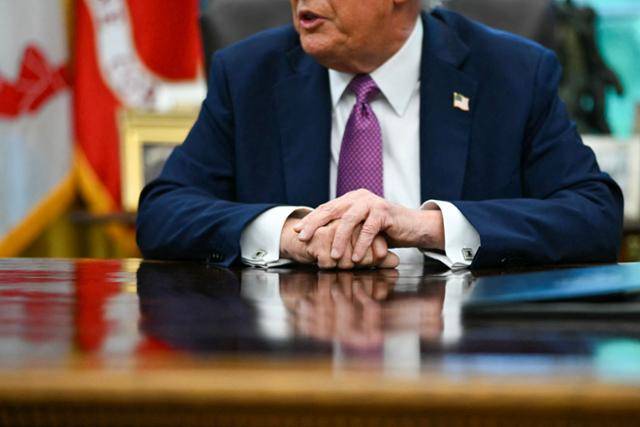 도널드 트럼프 미국 대통령이 5일 워싱턴 백악관 대통령 집무실에서 행정명령 서명식을 진행하며 기자들에게 질문을 받고 있다. 워싱턴=AFP 연합뉴스