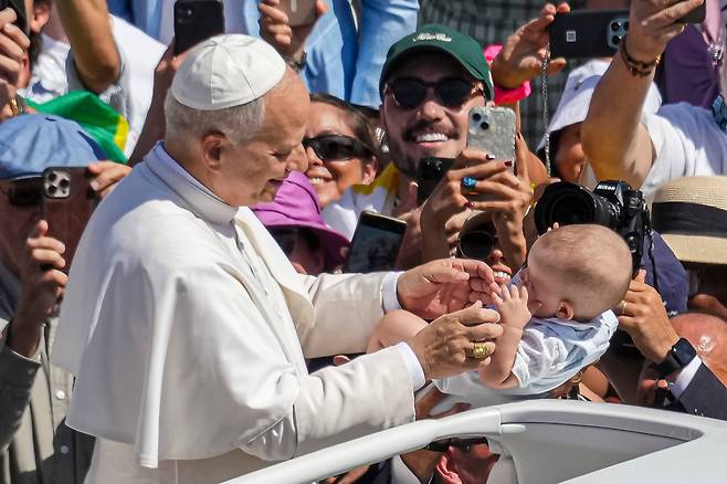 교황 레오 14세가 7일(현지시각) 바티칸 성 베드로 광장에서 카를로 아쿠티스와 피에르 조르조 프라사티의 시성 미사를 집전한 뒤 자리를 떠나던 중 아이를 축복하고 있다. /AP·연합뉴스