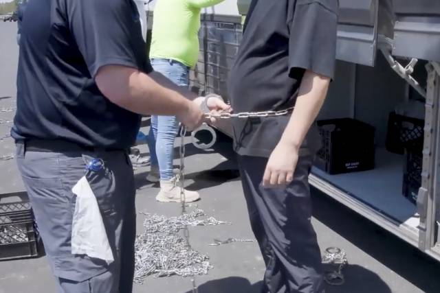 미국 이민세관집행국이 공개한 영상에 한 미 이민당국 관계짜가 지난 4일(현지 시간) 조지아주 현대차그룹-LG에너지솔루션 합작 배터리 공장 건설 현장에서 한 사람에게 수갑을 채우고 있다. AP연합뉴스