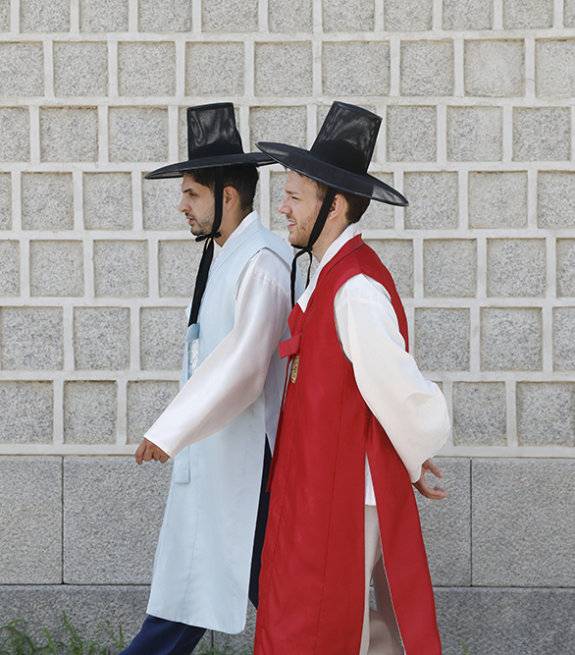 갓을 쓴 관광객이 경복궁을 거닐고 있다.