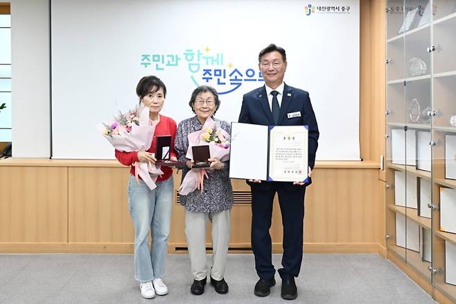 김제선 대전 중구청장(사진 오른쪽)이 지난 9일 6.25전쟁에 참전하여 공을 세운 故 이영훈 상사 유가족에게 금성화랑 무공훈장과 증서를 전수하고 기념촬영을 하고 있다. 대전중구