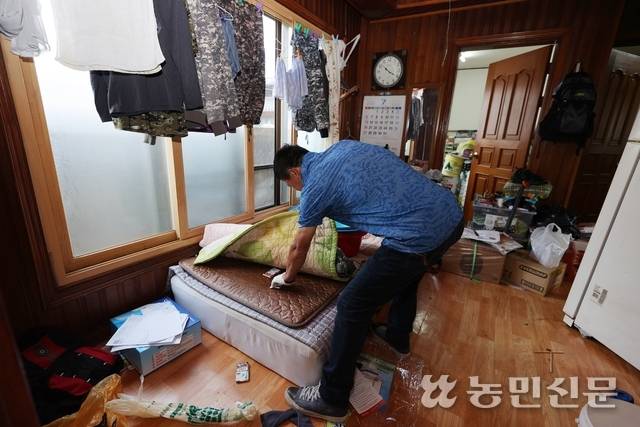 고독사 현장에서 유품 정리하는 권영이씨의 뒷모습. 김원철 프리랜서 사진기자