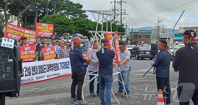 지난 10일 전남 영암군청 앞에서 열린 '신해남∼신장성 345㎸(킬로볼트) 송전선로 건설사업' 반대집회에 참여한 주민들이 모형 철탑을 부수는 퍼포먼스를 벌이고 있다.(주민대책위 제공, 재배포 및 DB 금지)/뉴스1