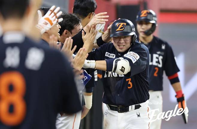 스리런홈런을 치고 동료들에게 축하받는 안치홍.  한화 이글스 제공