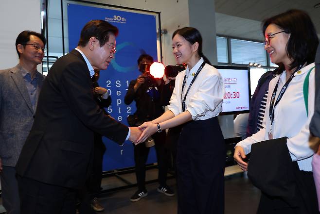 이재명 대통령이 20일 부산국제영화제 공식상영작 '극장의 시간들' 관람을 위해 방문한 부산 해운대구 영화의전당에서 배우 고아라와 인사하고 있다. 연합뉴스
