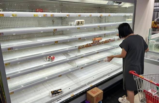 23일 홍콩의 한 슈퍼마켓 상품 진열대가 태풍의 영향으로 텅 비어있다. AFP 연합뉴스.