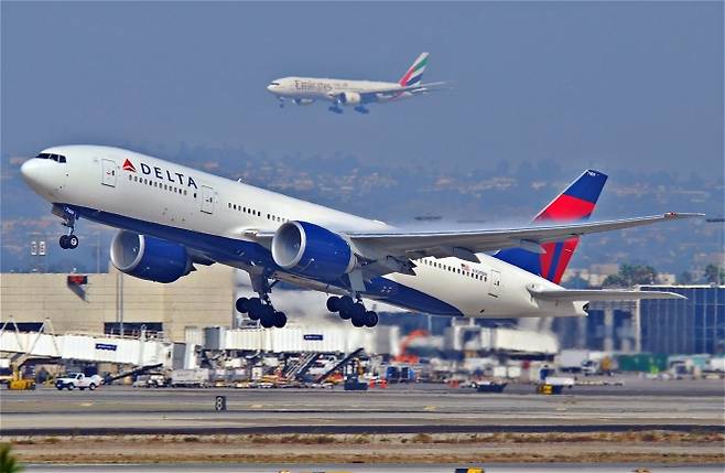 2011년 2월 25일(현지시간)  미국 캘리포니아주 로스앤젤레스공항에서 델타항공 777-232LR 여객기가 첫 비행에 오르고 있다. 그 뒤로는 에미레이트항공 여객기가 착륙하고 있다. 플리커(에어로 이카루스) 자료. 기사와 직접 관련 없음